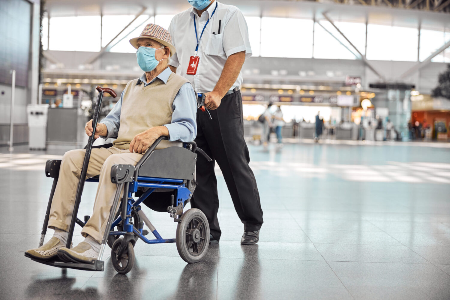 elderly gentleman being pushed in a wheelchair